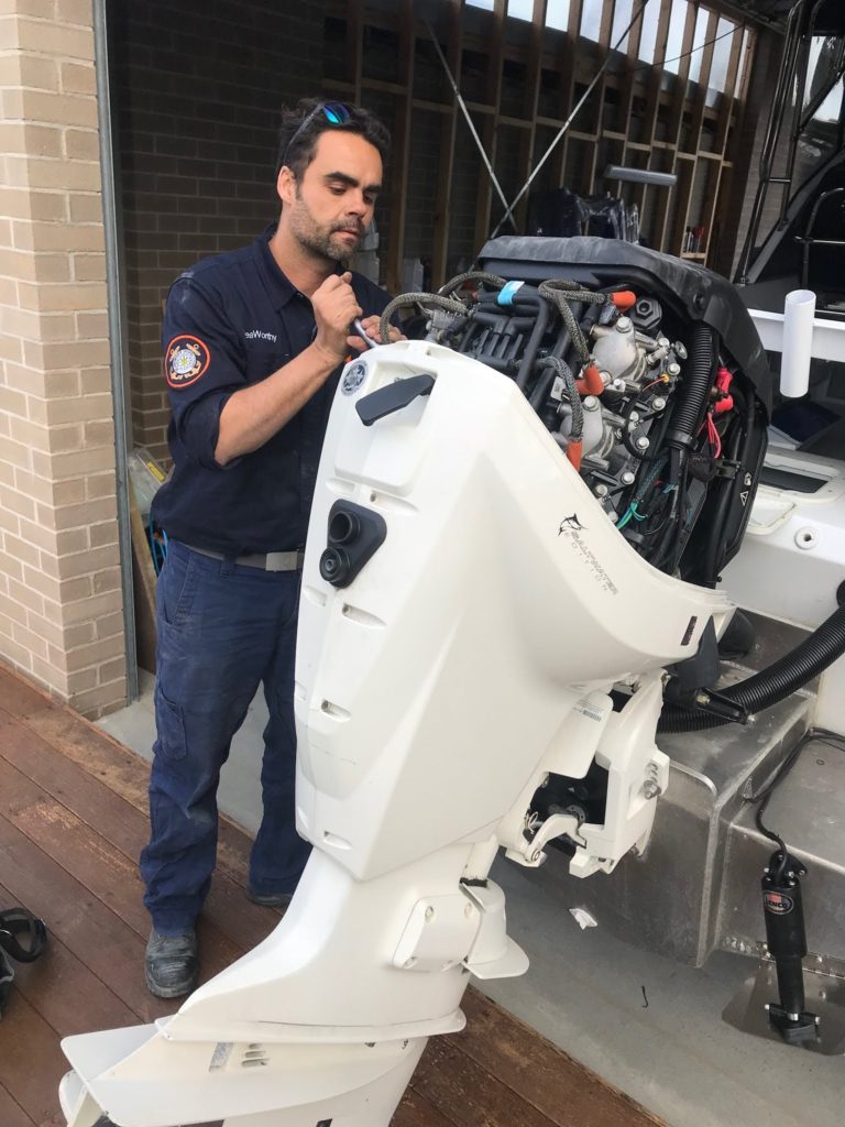 Mechanic fixing outboard motor